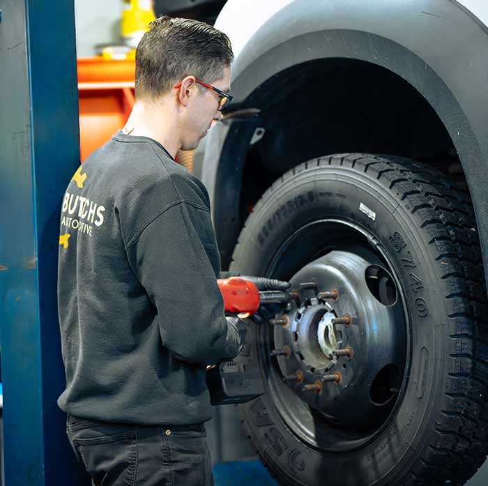 Butchs technician servicing a vehicle on the lift