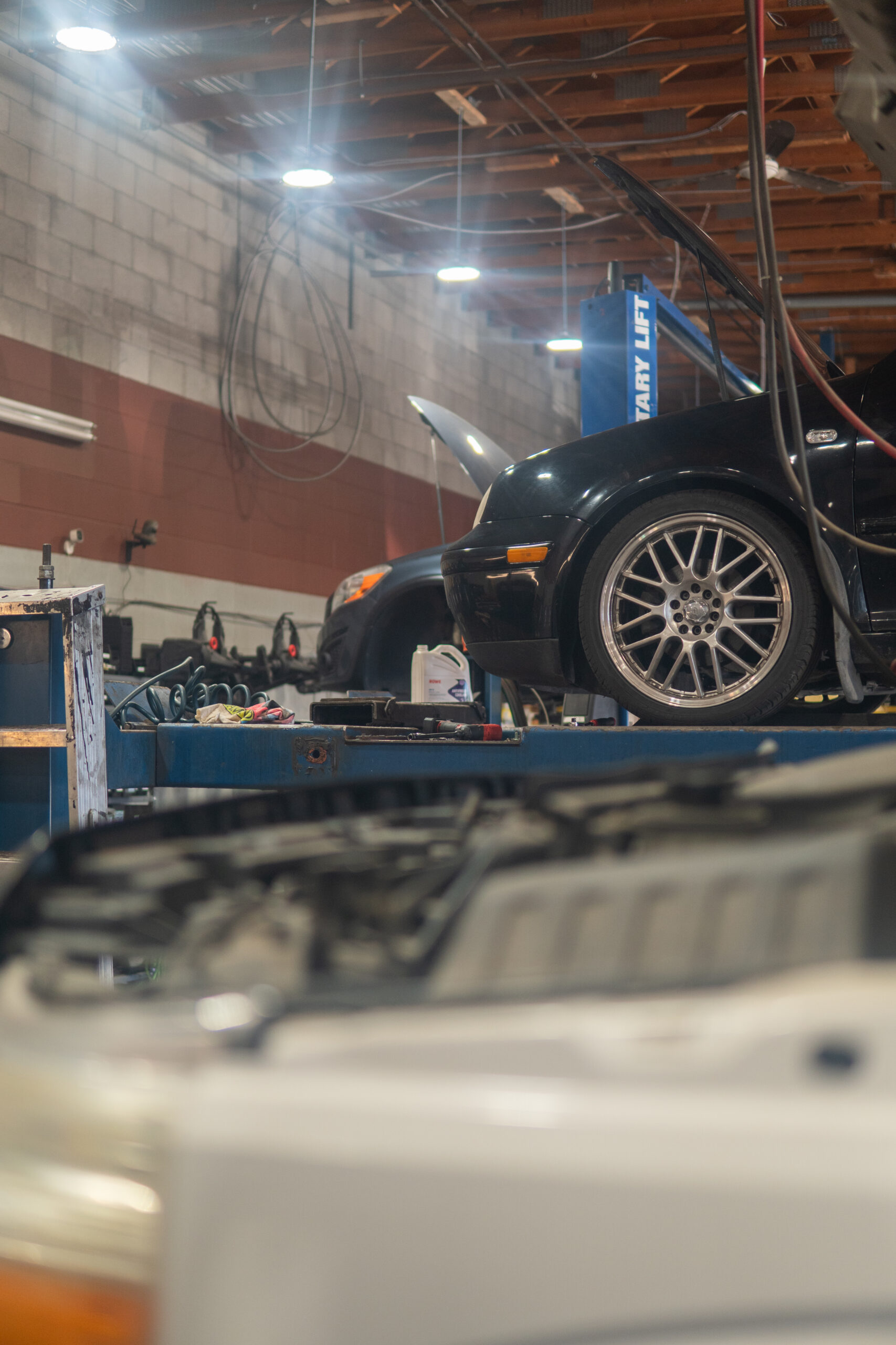Vehicle raised on a hoist for brake service at Butch&rsquo;s Automotive